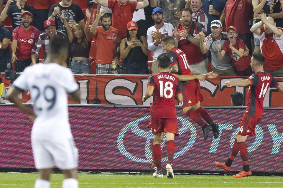 Toronto FC's Sebastian Giovinco, center, celebrates scoring against the Vancouver Whitecaps during the first half in the second leg of the Canadian soccer championship final, Wednesday, Aug. 15, 2018, in Toronto. (Chris Young/The Canadian Press via AP)