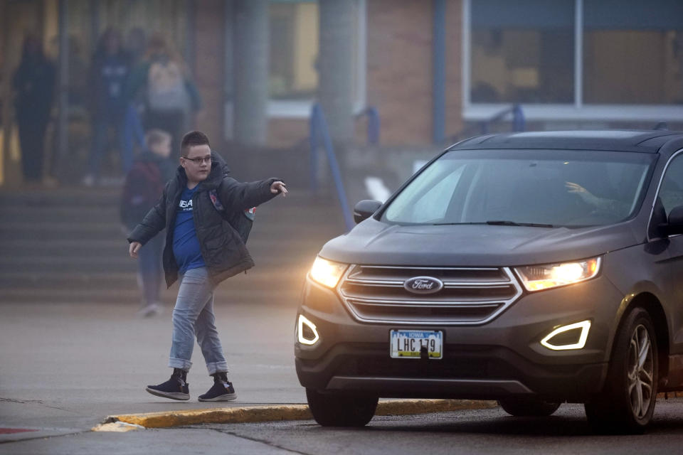 A student arrives at Perry Middle School, Thursday, Jan. 25, 2024, in Perry, Iowa. Middle school students returned to classes Thursday for the first time since a high school student opened fire in a shared cafeteria, killing two people and injuring six others. (AP Photo/Charlie Neibergall)