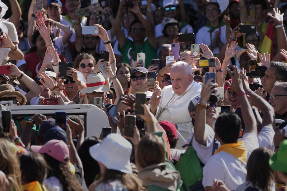 Pope Francis arrives at Lisbon's Parque Eduardo VII to preside over a 'Via Crucis' (Way of the Cross) with young people participating into Sunday's 37th World Youth Day in the Portuguese capital, Friday, Aug. 4, 2023. Francis is in Portugal through the weekend to preside over the jamboree that St. John Paul II launched in the 1980s to encourage young Catholics in their faith. (AP Photo/Armando Franca)