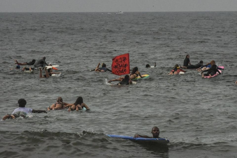 Surfers in the water off Rockaway Beach in the Queens borough of New York City in August 2021 (Getty Images)