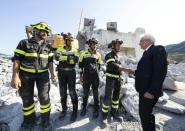 Italian President Sergio Mattarella (R) visited the disaster site before attending the state funeral on Saturday