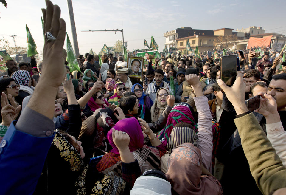 Supporters of former Pakistani Prime Minister Nawaz Sharif shout slogans against the government outside an accountability court in Islamabad, Pakistan, Monday, Dec. 24, 2018. Pakistan's anti-graft court is set to announce ruling in two corruption cases against Sharif. Sharif, accused of possessing assets beyond known sources of income, will be sent to jail if he is sentenced. (AP Photo/B.K. Bangash)