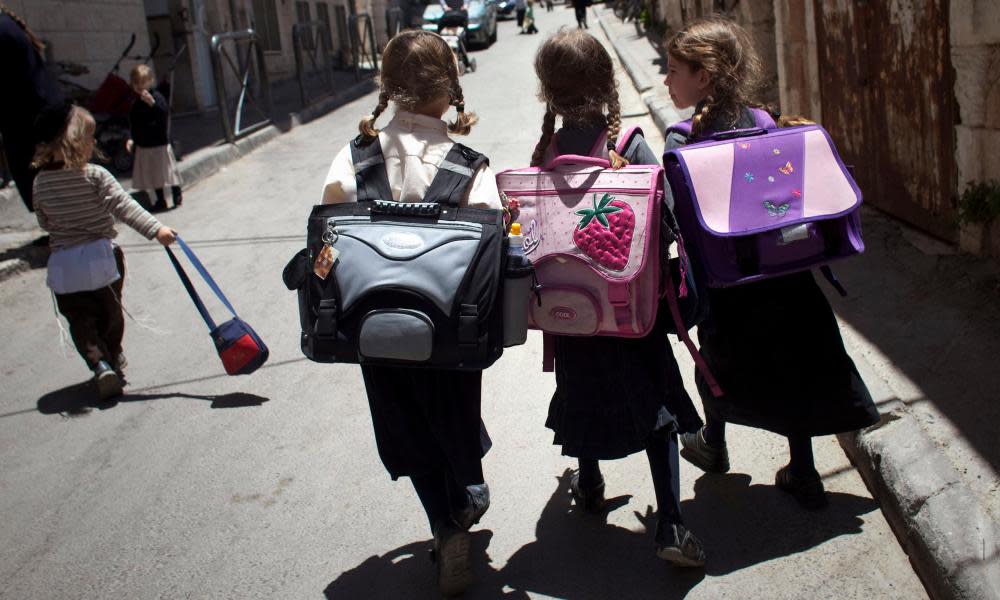 Jewish girls walk home from school in Jerusalem. Critics of the law say it could be used to block anyone who criticises Israel to a foreign entity from speaking in schools.