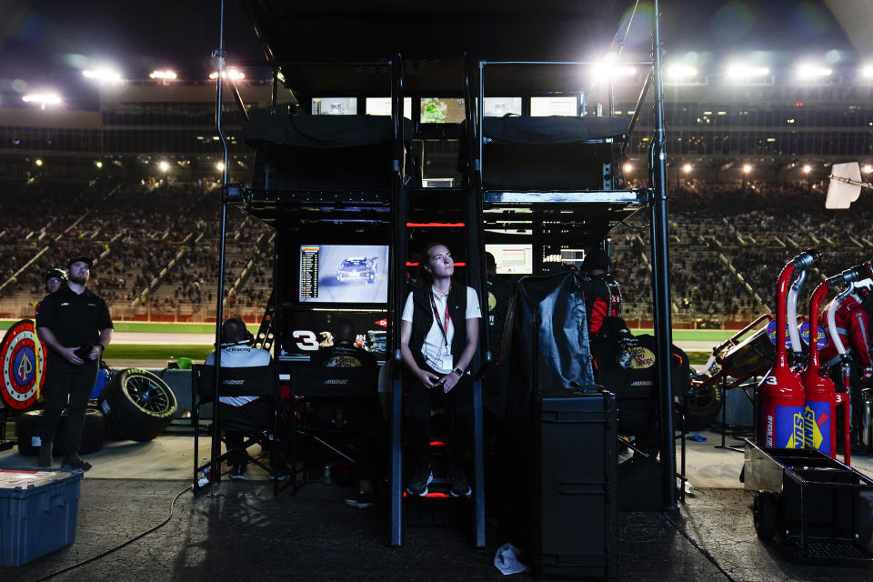 A person watches a screen after a wreck during a NASCAR Cup Series auto race at Atlanta Motor Speedway on Sunday, July 9, 2023, in Hampton, Ga. (AP Photo/Brynn Anderson)