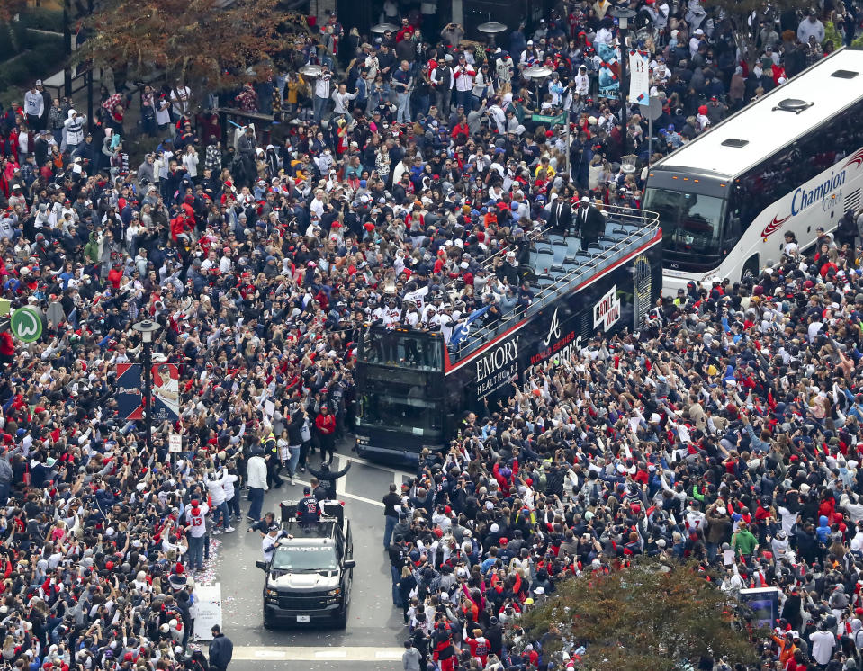Fans cheer the 2021 World Series baseball champion Atlanta Braves during a victory parade in Atlanta, Friday, Nov. 5, 2021. (Curtis Compton/Atlanta Journal-Constitution via AP)