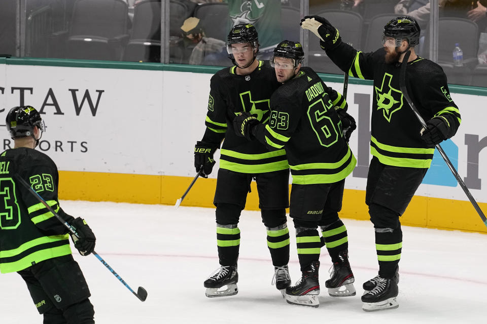 Dallas Stars right wing Evgenii Dadonov (63) celebrates with Esa Lindell (23), Wyatt Johnston (53) and Jani Hakanpaa (2) after scoring in the second period of an NHL hockey game against the Columbus Blue Jackets, Monday, Oct. 30, 2023, in Dallas. (AP Photo/Tony Gutierrez)