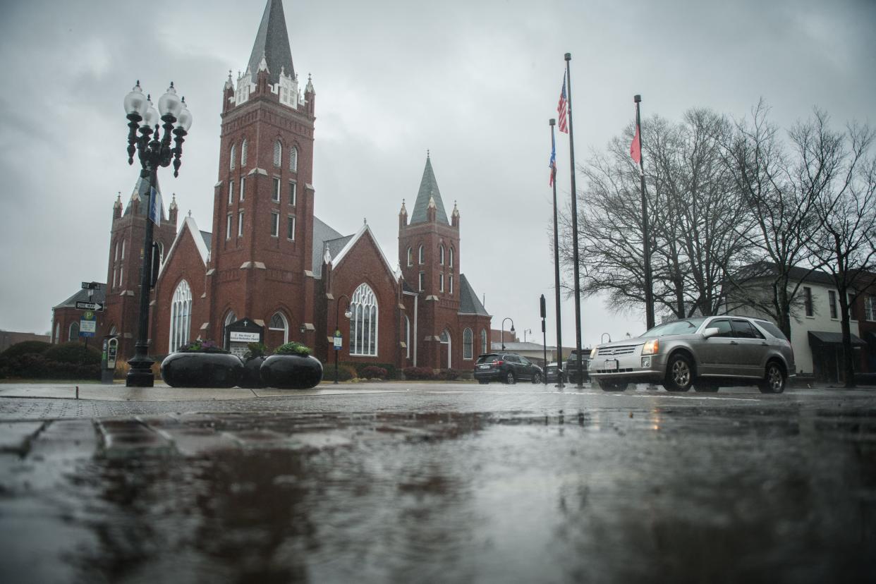 Rain starts coming down on Hay Street, Tuesday, Jan. 9, 2024.