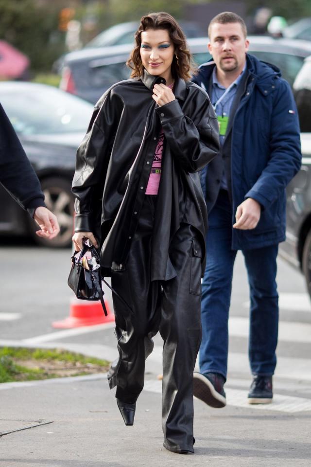 Bella Hadid in Red Tracksuit Carrying a Louis Vuitton Backpack