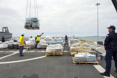 Armed crew members of the U.S. Coast Guard Cutter Stratton keeps watch as more than 66,000 pounds of cocaine worth $1.01 billion wholesale that was seized in the Eastern Pacific Ocean is unloaded upon arrival in San Diego, California August 10, 2015. REUTERS/Mike Blake