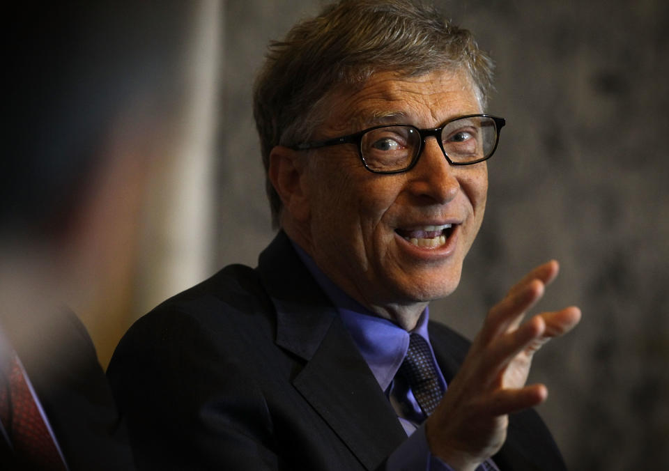 Close-up of Bill gesturing in a suit and tie