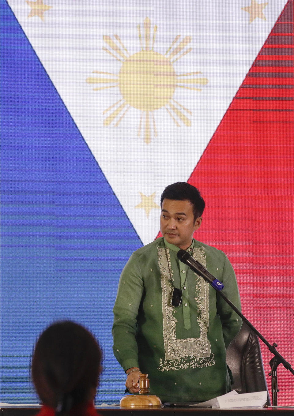 Representative Lord Allan Velasco bangs the gavel after being sworn in as new house speaker by supporters at the Celebrity sports club in Quezon city, Philippines, Monday, Oct. 12, 2020. A large faction of Philippine legislators in the House of Representatives has elected a new leader but the incumbent speaker declared the vote “a travesty” in a tense political standoff between two allies of the president. (AP Photo/Aaron Favila)