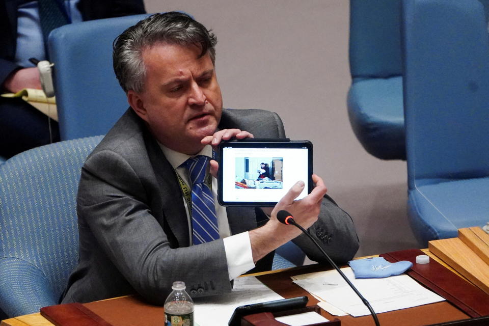 Sergiy Kyslytsya, Ukrainian ambassador to the U.N., presents a picture on an electronic device showing Marianna Podgurskaya from Mariupol during a Security Council meeting on Threats to International Peace and Security on Friday.