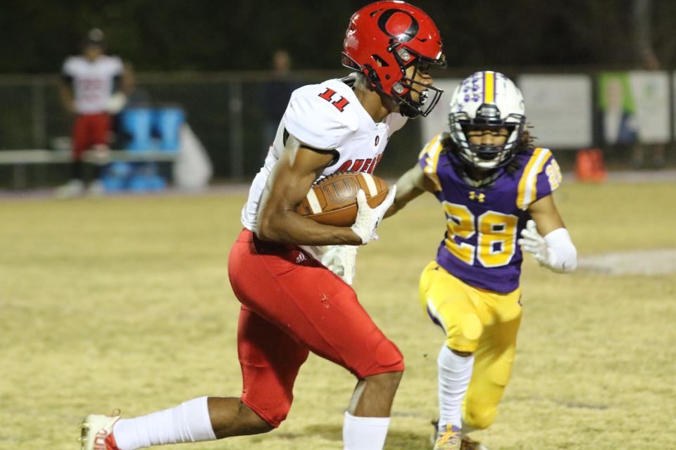 Overton wide receiver Tyson Edwards (11) looks for room to run after catching a short pass from Ryder Hagen in the first quarter as Clarksville's Isaiah Soto comes up to make the tackle during their Class 6A first-round playoff game Friday, Nov. 4, 2022 at Hilda J. Richardson Field in Clarksville, Tennessee.