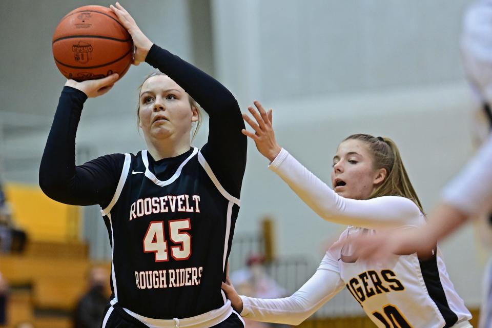 Roosevelt's Lexie Canning shoos while being pressured by Cuyahoga Falls' Alyssa Shay during the first half of their game Wednesday night at Cuyahoga Falls High School.