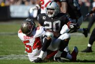 OAKLAND, CA - NOVEMBER 04: Darren McFadden #20 of the Oakland Raiders gets wrapped up by Lavonte David #54 of the Tampa Bay Buccaneers during the second quarter of their NFL football game at O.co Coliseum on November 4, 2012 in Oakland, California. (Photo by Thearon W. Henderson/Getty Images)