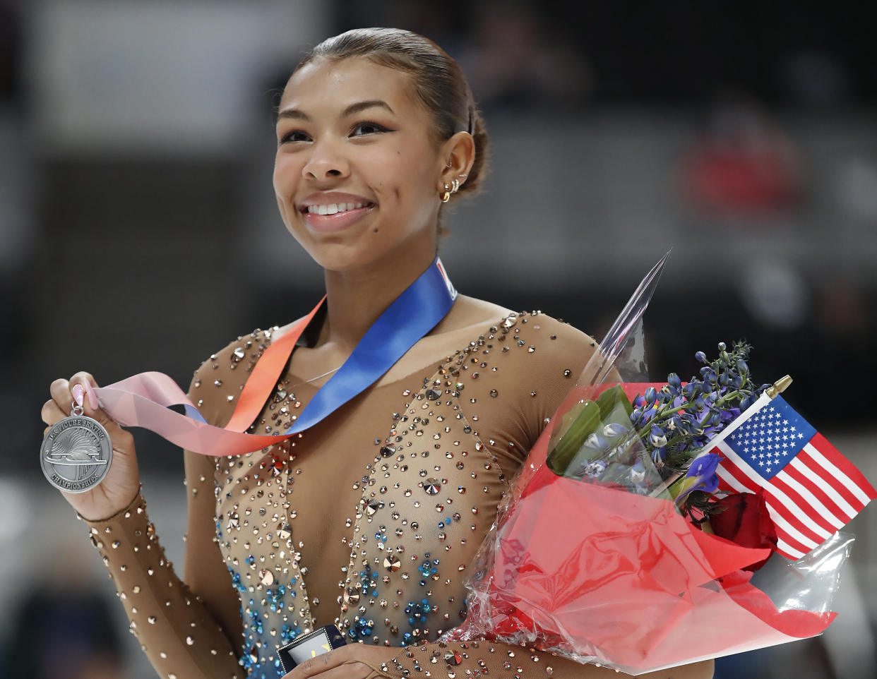 Starr Andrews holds up her medal after the women's free skate at the U.S. figure skating championships in San Jose, Calif., Friday, Jan. 27, 2023. Andrews finished fourth in the event. (AP Photo/Josie Lepe)