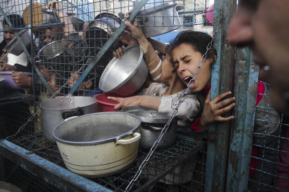 Palestinians line up to receive free meals at Jabaliya refugee camp in the Gaza Strip on Monday, March 18, 2024. (AP Photo/Mahmoud Essa)