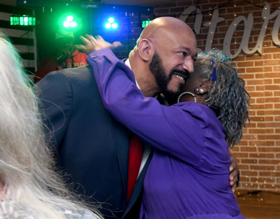 Democratic primary candidate for Canton mayor Thomas West gets a hug from Ward 4 Councilwoman Chris Smith as they wait for election day results at Starz in Canton.