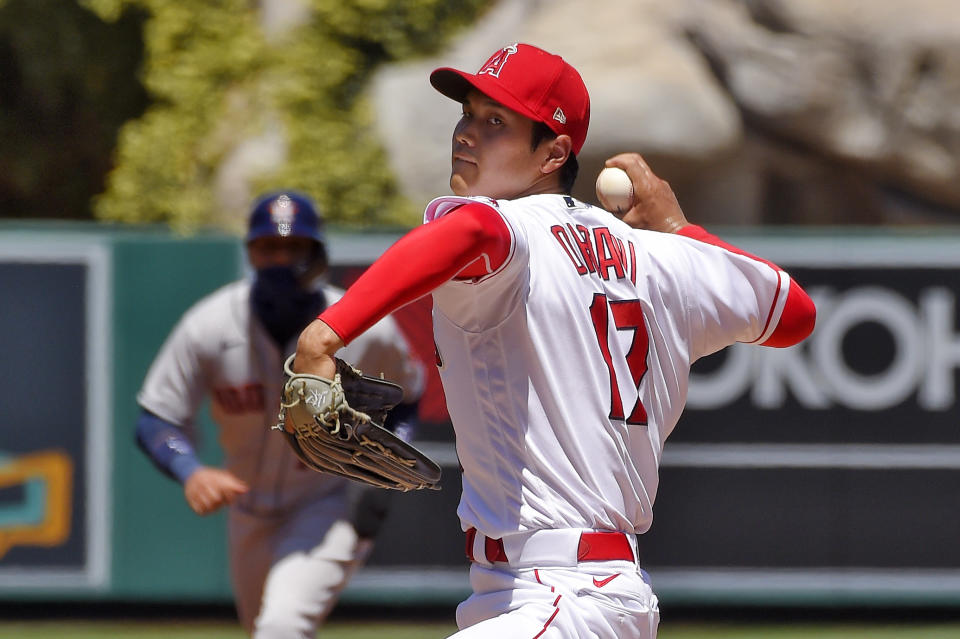 Los Angeles Angels pitcher Shohei Ohtani, right, of Japan, throws to the plate as Houston Astros' Yuli Gurriel stands at second during the second inning of a baseball game Sunday, Aug. 2, 2020, in Anaheim, Calif. (AP Photo/Mark J. Terrill)