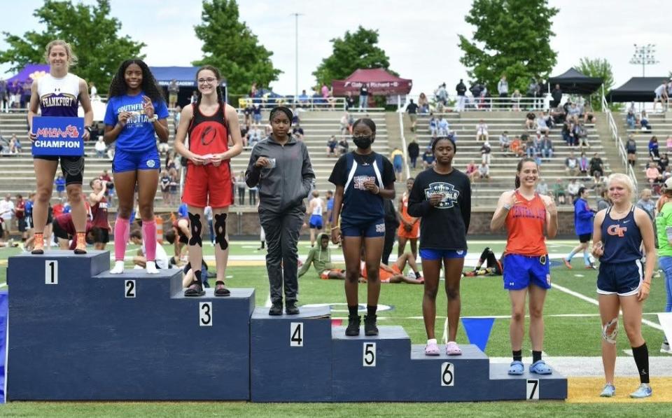 Onaway's Madilyn Crull (third from left) stands on the podium after earning all-state in the girls 100.