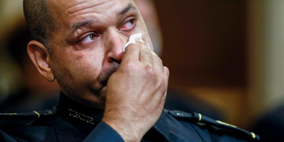 A US Capitol Police officer, Aquilino Gonell, wiping away tears.