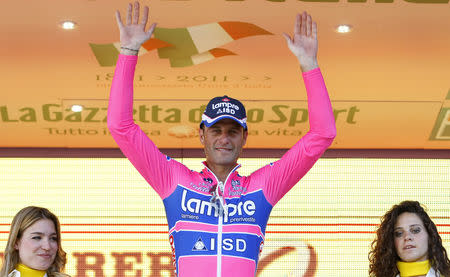 FILE PHOTO: Lampre-ISD's Alessandro Petacchi of Italy celebrates on the podium after winning the 244km second stage of the Giro d'Italia cycling race from Alba to Parma May 8, 2011. HTC-Highroad's Mark Cavendish of Britain took the leader's pink jersey. REUTERS/Alessandro Garofalo