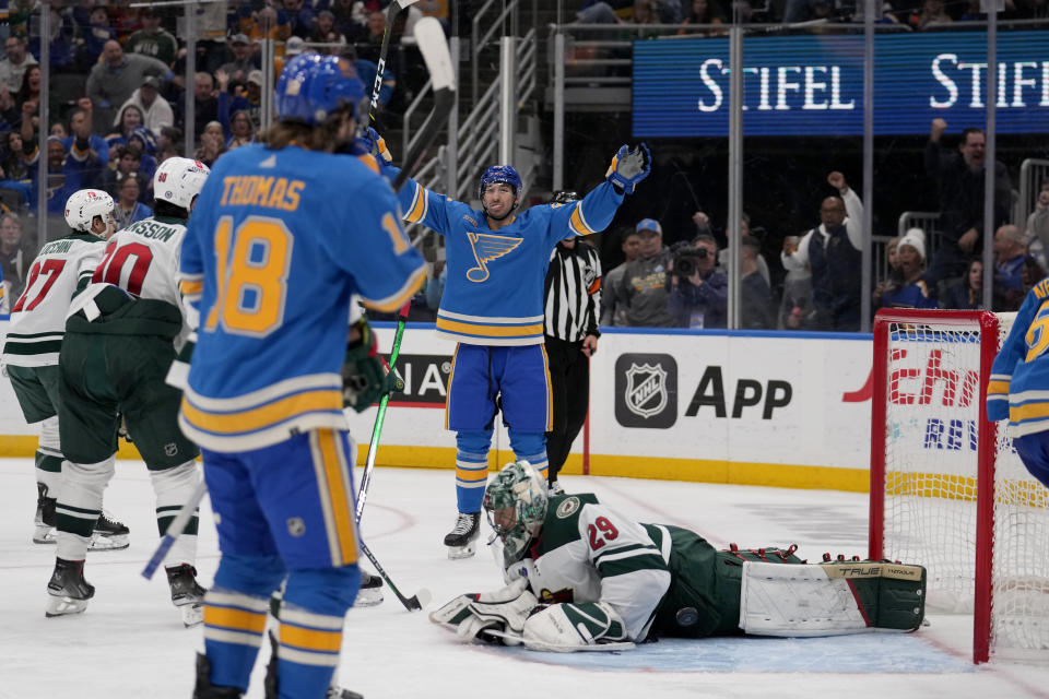 CORRECTS ID TO BLUES' JORDAN KYROU INSTEAD OF BRAYDEN SCHENN - St. Louis Blues' Jordan Kyrou celebrates after scoring past Minnesota Wild goaltender Marc-Andre Fleury (29) as Blues' Robert Thomas (18) watches during the second period of an NHL hockey game, Saturday, March 16, 2024, in St. Louis. (AP Photo/Jeff Roberson)