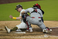 San Diego Padres' Jake Cronenworth, left, scores off a fielder's choice by Manny Machado as St. Louis Cardinals catcher Yadier Molina, right, reaches for the ball during the seventh inning of Game 3 of a National League wild-card baseball series Friday, Oct. 2, 2020, in San Diego. (AP Photo/Gregory Bull)