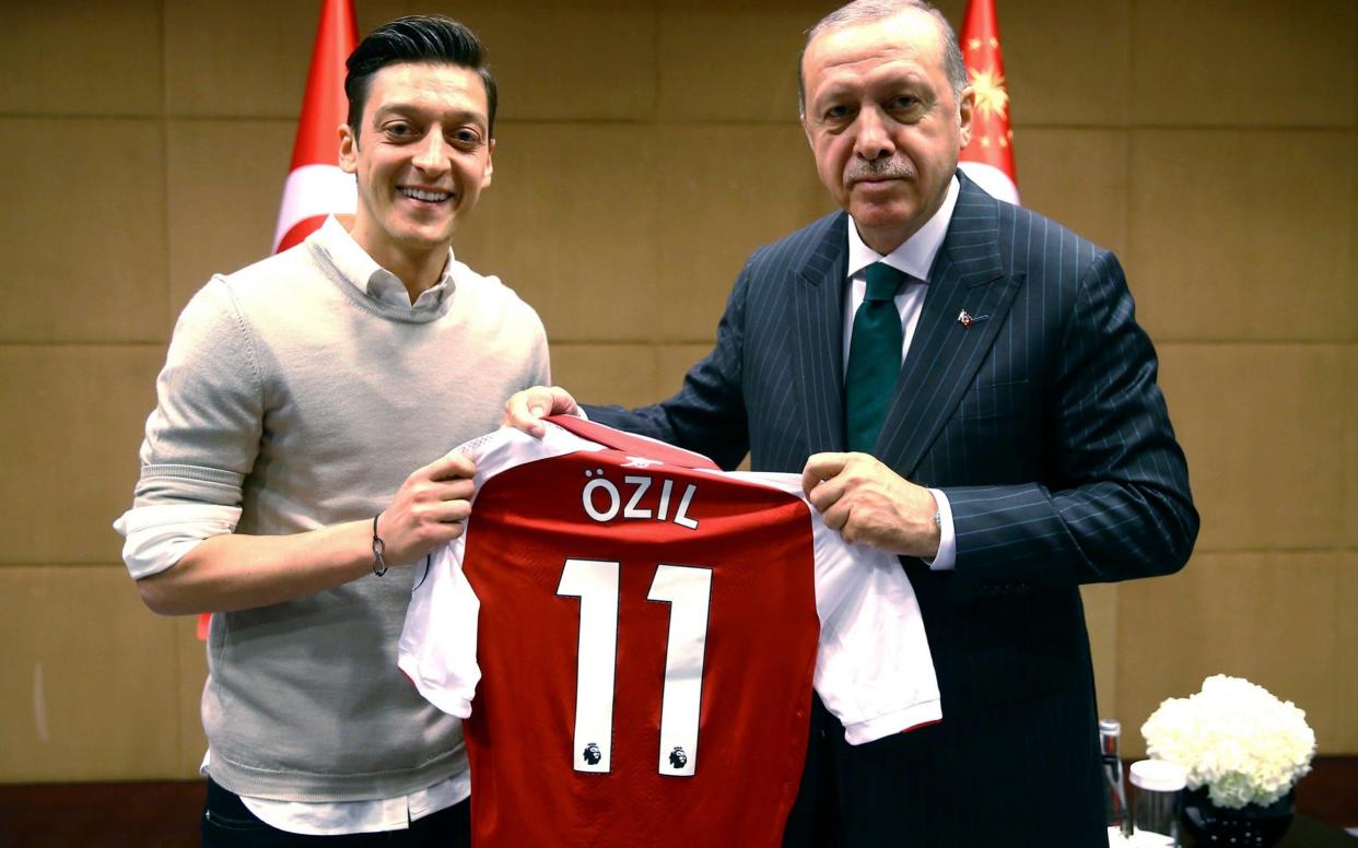 Football stars Mesut Özil (pictured, left) and Ilkay Gündogan posed with the Turkish president in London on Sunday May 13  - Pool Presdential Press Service