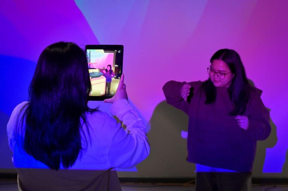 Students engaging with augmented reality art made in one of the Creative Technologies courses.