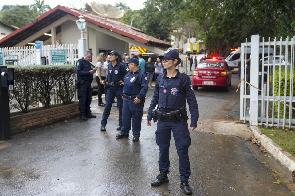 Police guard the gated community where a plane crashed in Vinhedo, Sao Paulo state, Brazil, Friday, Aug. 9, 2024. (AP Photo/Andre Penner)