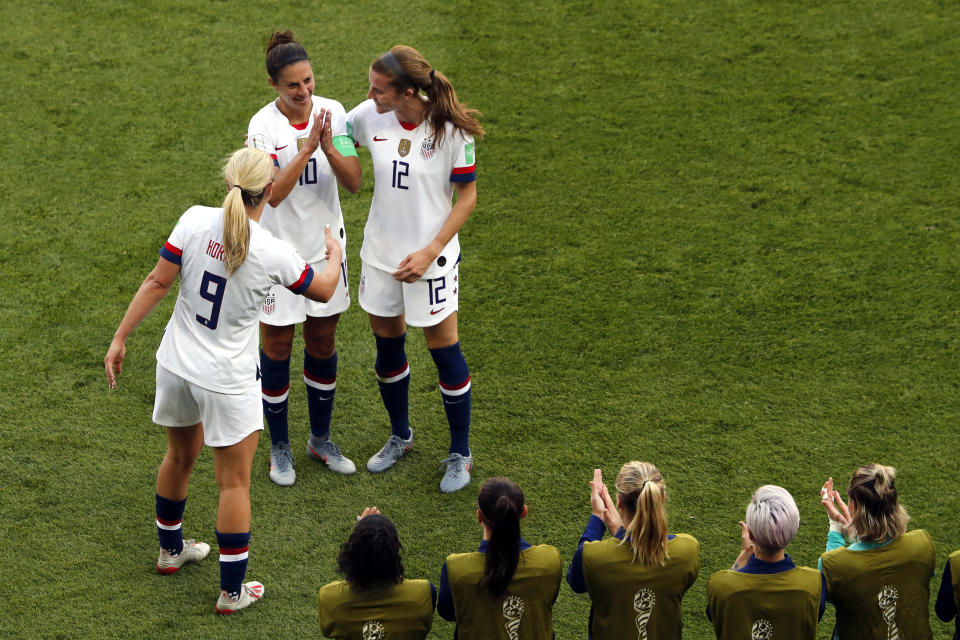 United States' Carli Lloyd, top center, celebrates with Lindsey Horan and Tierna Davidson, right, after scoring the opening goal during the Women's World Cup Group F soccer match between the United States and Chile at the Parc des Princes in Paris, Sunday, June 16, 2019. (AP Photo/Thibault Camus)