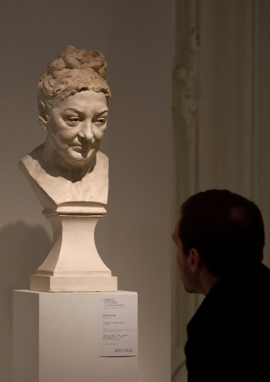 A visitor to Artcurial auction house admires a Claudel sculpture depicting her mother