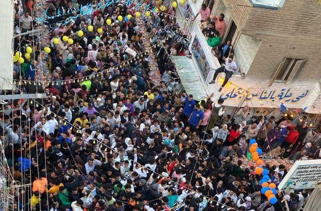 People pack a crowded street in the Matareya neighborhood, in Egypt's capital city of Cairo, for an annual mega-Iftar dinner on the 15th day of Ramadan, March 25, 2024, in Egypt. / Credit: CBS News/Ahmed Shawkat