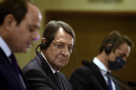 Cyprus President Nicos Anastasiades, center, Greece's Prime minister Kyriakos Mitsotakis, right, and Egypt's President Abdel-Fattah el-Sissi talk to the media during a press conference after their meeting at the presidential palace in capital Nicosia, Cyprus, on Wednesday, Oct. 21, 2020. The leaders of Cyprus, Egypt and Greece meet in the Cypriot capital for talks on forging closer ties and boosting cooperation on issues including energy following the discovery of gas deposits in the east Mediterranean. (Iakovos Hatzistavrou Pool via AP)