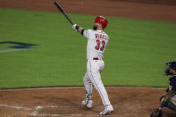 Cincinnati Reds' Jesse Winker watches his solo home run during the eighth inning of a baseball game against the Milwaukee Brewers in Cincinnati, Friday, May 21, 2021. The home run was his third of the game. (AP Photo/Aaron Doster)