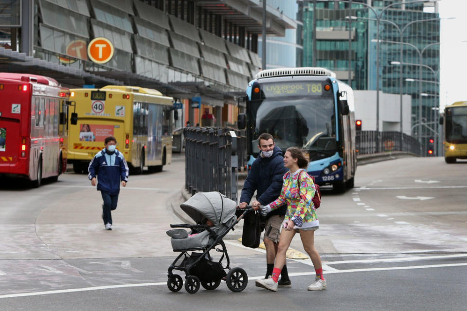 Pedestrians move through the usually bustling Parramatta transit hubin Sydney, Australia. 