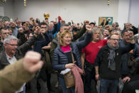 Striking dock workers gesture, during a union assembly at the Marseille port in southern France, Thursday, Jan. 23, 2020. Protesters marched in Paris against French President Emmanuel Macron's plans to overhaul the pension system. (AP Photo/Daniel Cole)