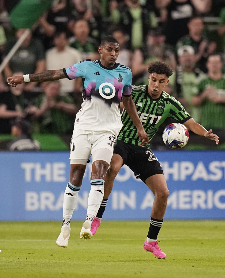 Minnesota United midfielder Joseph Rosales (8) and Austin FC midfielder Sofiane Djeffal (22) chase a pass during the second half of an MLS soccer match Wednesday, May 31, 2023, in Austin, Texas. (AP Photo/Eric Gay)