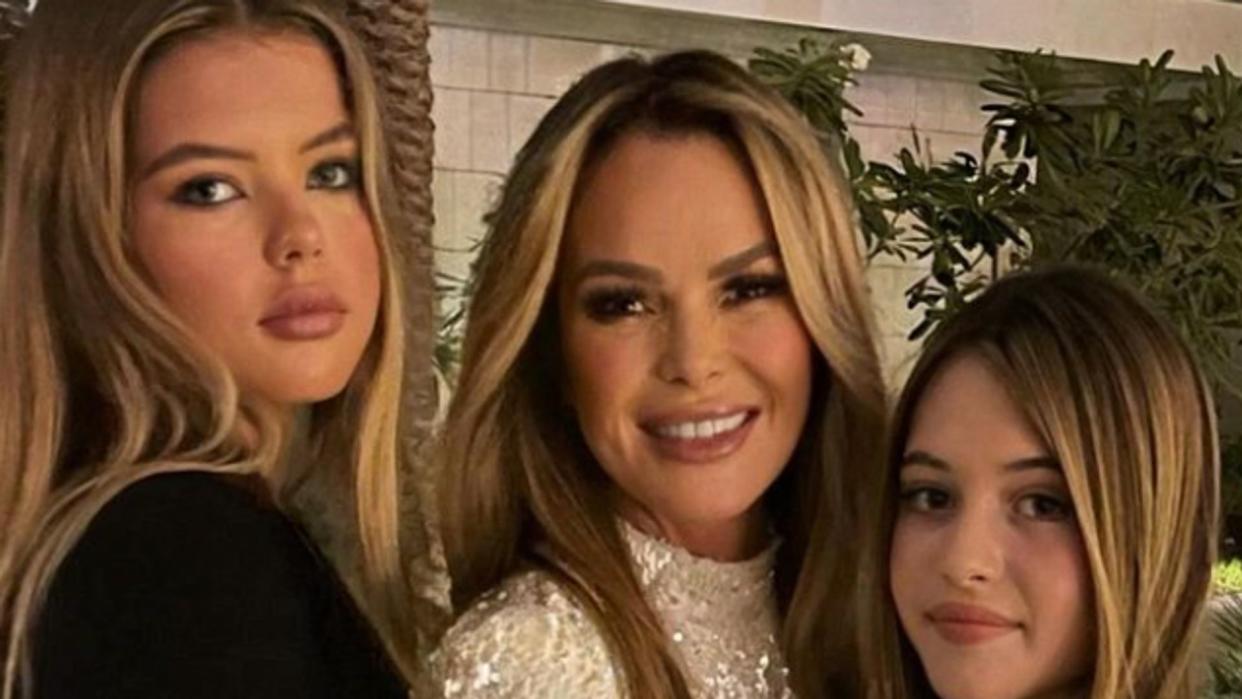 Amanda Holden posing with her two daughters