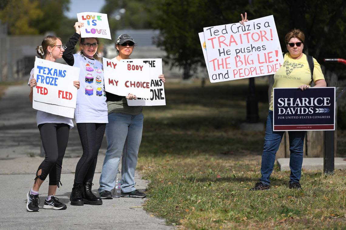 Counter protesters Abby Bird, from left, Cameron Bird, Beth Bird and Barb Musik of Ottawa, Kansas, stood outside a rally for Amanda Adkins, the Republican candidate in Kansas’ 3rd Congressional District, who was endorsed by Sen. Ted Cruz, during the event Friday, Oct. 14, 2022, in Ottawa, Kansas.