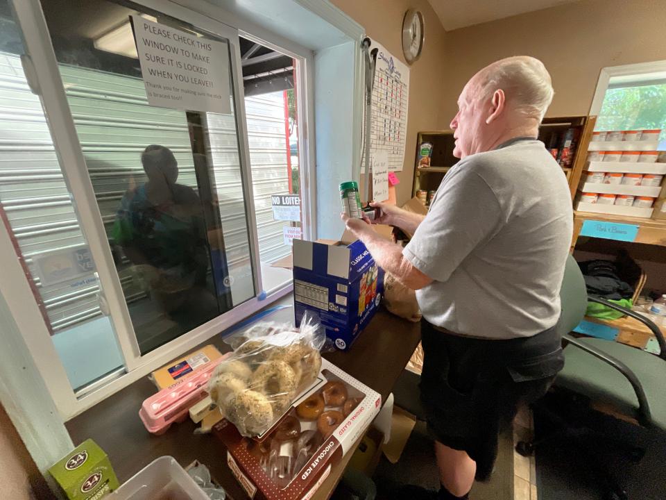 Sharing & Caring food pantry volunteer Herb Mason Jr. talks with a client at the facility in Fort Walton Beach. On Thursday, Sharing & Caring hosted a groundbreaking ceremony for a new expansion to the existing building.