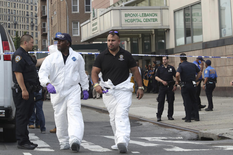 <p>Police officers with the Forensics Unit leave Bronx Lebanon Hospital after a gunman opened fire and then took his own life there, Friday, June 30, 2017, in New York. The gunman, identified as Dr. Henry Bello who used to work at the hospital, returned with a rifle hidden under his white lab coat, law enforcement officials said. (AP Photo/Mary Altaffer) </p>