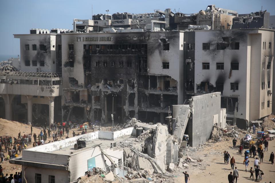 Palestinians inspect the damage at Gaza's Shifa hospital after the Israeli military withdrew from the complex housing the hospital on April 1, 2024.