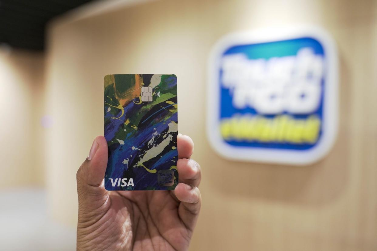 A picture of the new Touch 'n Go Visa card in front of the Touch 'n Go logo.