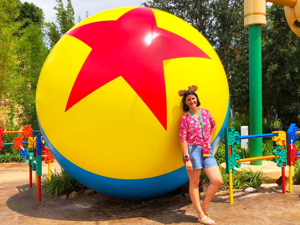 the writer leaning on a luxo ball at disney 
