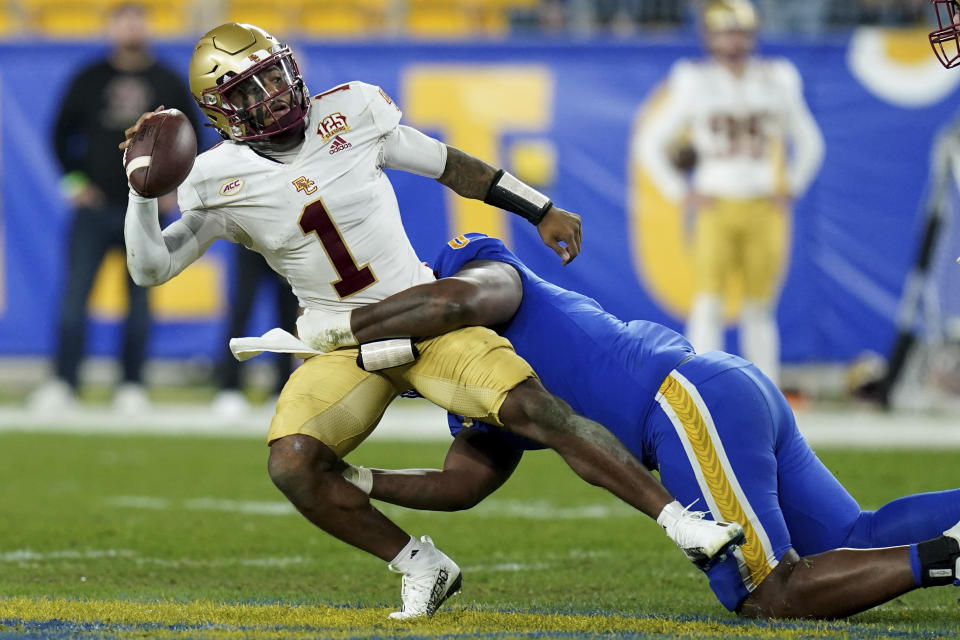 Pittsburgh defensive lineman Deandre Jules (0) sacks Boston College quarterback Thomas Castellanos (1) during the first half of an NCAA college football game against Boston College, Thursday, Nov. 16, 2023, in Pittsburgh. (AP Photo/Matt Freed)