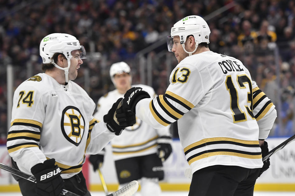 Boston Bruins center Charlie Coyle, right, celebrates with left wing Jake DeBrusk after scoring against the Buffalo Sabres during the first period of an NHL hockey game in Buffalo, N.Y., Wednesday, Dec. 27, 2023. (AP Photo/Adrian Kraus)