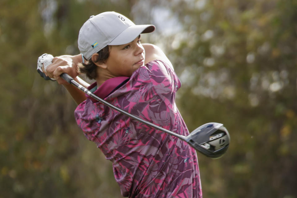 Charlie Woods tees off during the final round of the PNC Championship golf tournament, Sunday, Dec. 17, 2023, in Orlando, Fla. (AP Photo/Kevin Kolczynski)