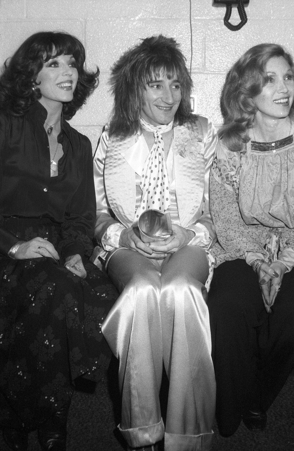 <p>Joan Collins and Alison Steele join rocker Rod Stewart backstage at Madison Square Garden after a Faces show in 1975. Stewart left the rock group later that year. </p>